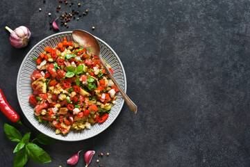 Spicy salad of baked eggplant, peppers and tomatoes. Eggplant caviar. Village ratatouille.