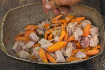Pilaf in a cauldron with spoon
