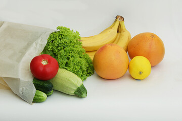 online shopping in online stores during isolation and to save time. Paper bag filled with fruit and vegetables zucchini, bananas, grapefruits, lettuce, tomatoes, cucumbers, lemon