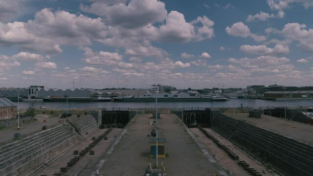 Symmetrical shot revealing two empty drydocks in an abandoned shipyard. Inspire2 X7 12mm prores