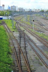 Trains at railroad yard at station district
Industrial background featuring detail of electrical railroad with rails and contact lines. Modern, bridge.
