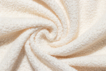 Beige background wool texture swirled into spiral pattern. Sheep fluffy warm fur. Tender twisted...