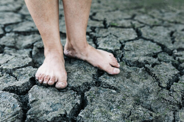 bare feet on cracked desert soil