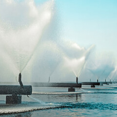 Thermal power plant cooling system, cooling pool water, fountains sprays water  on a sunny  sky...
