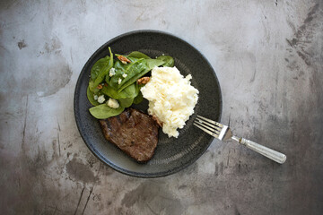 Steak with Mashed Potatoes and Spinach Salad