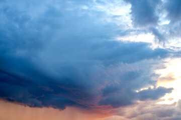 Naklejka na ściany i meble Dark dramatic stormy cloudscape with sunlight