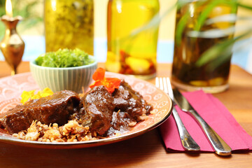 Beef cheeks braised in red wine. Traditional Jewish cuisine.
Appetizing dish. Suggestion of serving a dish. Culinary photography.