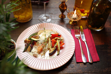 Salmon with grilled vegetables on vegetable puree.
Appetizing dish. Suggestion of serving a dish. Culinary photography.