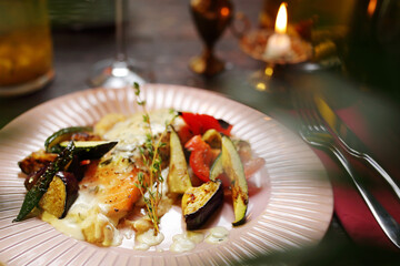 Salmon with grilled vegetables on vegetable puree.
Appetizing dish. Suggestion of serving a dish. Culinary photography.