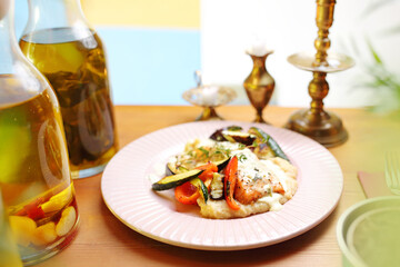 Salmon with grilled vegetables on vegetable puree.
Appetizing dish. Suggestion of serving a dish. Culinary photography.