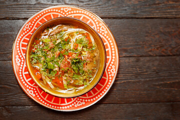 Duck broth with noodles. Appetizing dish. Suggestion of serving a dish. Culinary photography.