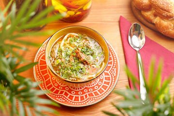 Chicken broth with noodles. Appetizing dish. Suggestion of serving a dish. Culinary photography.