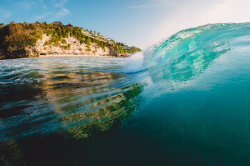 Perfect barrel wave in ocean. Breaking wave with sun light