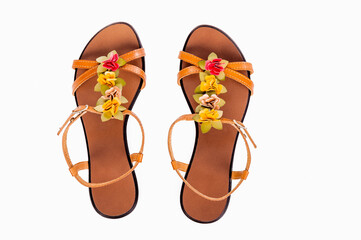 Female shoes isolated on the white background. Female sandals with a leather decorations in the...