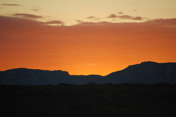 Sunset over the hills of the Brazilian Northeast with an orange sky