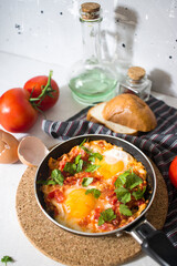 Breakfast. Shakshuka. Fried eggs with tomatoes and peppers.