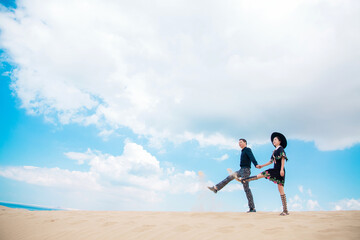 A couple traveling in the desert.