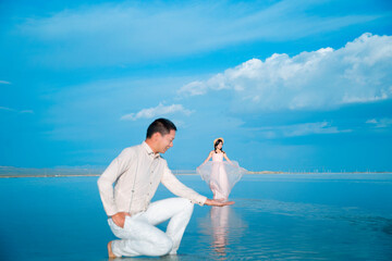 A couple frolicking in a lake in the sea.