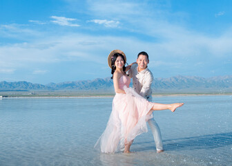 Fototapeta na wymiar A couple frolicking in a lake in the sea.