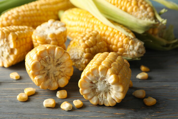 Composition with fresh raw corn on gray wooden table