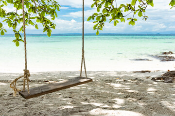 Wooden swing on the beach at Koh Munnork island, Thailand.
