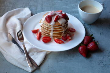 homemade pancakes with strawberry and coffee on the side