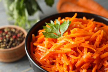 Composition with tasty carrot salad on wooden background. Korean carrot
