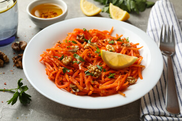 Composition with tasty carrot salad on gray background. Korean carrot