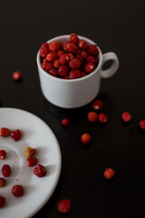 strawberry in a white Cup on a black background