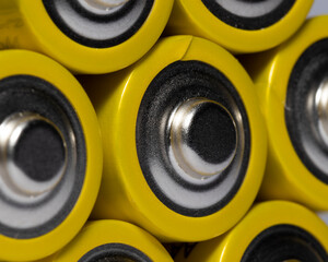 Macro shot of AA batteries yellow on white background