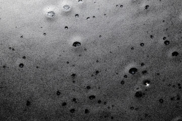 Craters in dark rock pitted