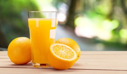 Orange juice and slices of orange on desk