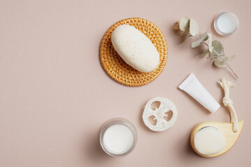 Flat lay composition with SPA cosmetics and bathroom accessories on beige background. Skin care concept.