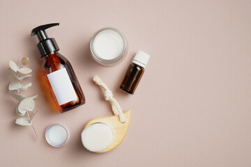 Flat lay composition with bathroom cosmetics, essential oil, shampoo, body cream, facial cleaning...