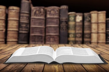 Open book on old wooden table.