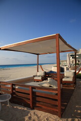 View of Caribbean beach with seaside resort and wooden pavilion at Cancun, Mexico