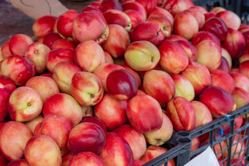 Fototapeta na wymiar Fresh and tasty natural peach in a market stall