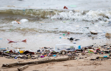 Trash on the Beach. Beach pollution. Plastic bottles and other trash on sea beach. Dirty sea sandy shore the Black Sea.