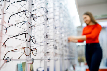 Eyeglasses shop. Stand with glasses in the store of optics. Showcase with spectacles in modern...