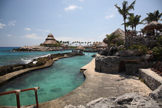 A scenic view of nature park  Xcaret with rocks and ocean under blue sky in playa del carmen Mexico