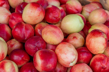 Fresh and tasty natural peach in a market stall