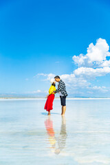 A couple frolicking in a lake in the sea.