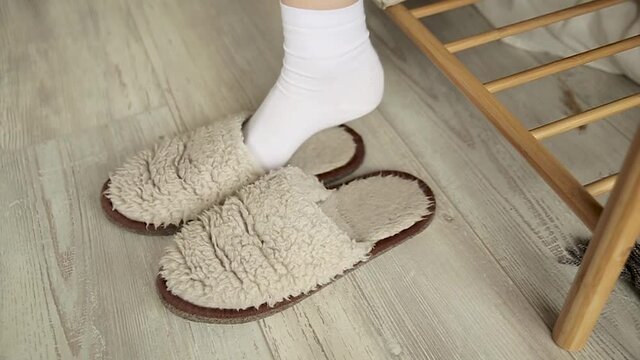 Girl puts on home-made fur slippers on socks