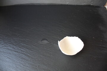 the eggshell lies on a grey stone black background with a place to insert text