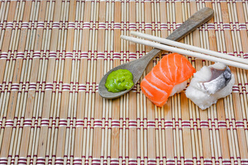 Shushi Japanese Food and salad roll on wooden table.Sushi rolls with salmon, soy sauce and chopsticks