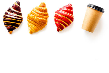Set of coffee with croissants - chocolate, berry, classic - on white top view