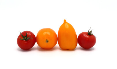 Red and yellow tomatoes on a light background. Natural product. Natural color. Close-up.
