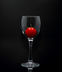 Red ripe tomato in a glass goblet. Natural product. Natural color. Close-up.
