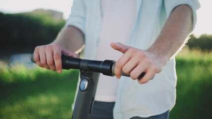 Close up of male hands and an electric scooter