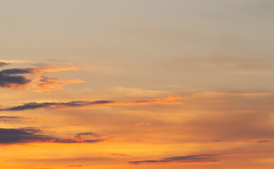 Sunset. Fuzzy cloud outlines in orange haze. Natural background.